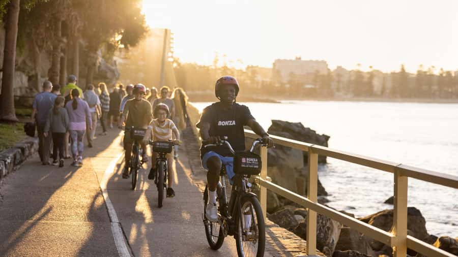 Breathtaking Manly Beach Bicycle and Sunset Cruise Tour - The sunset cruise return under the Opera House and Harbour Bridge